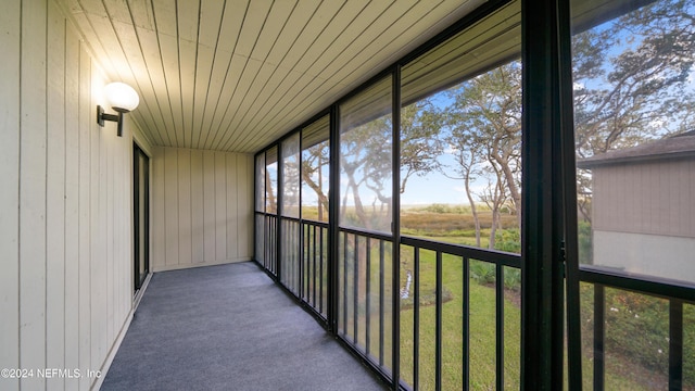 unfurnished sunroom featuring wooden ceiling