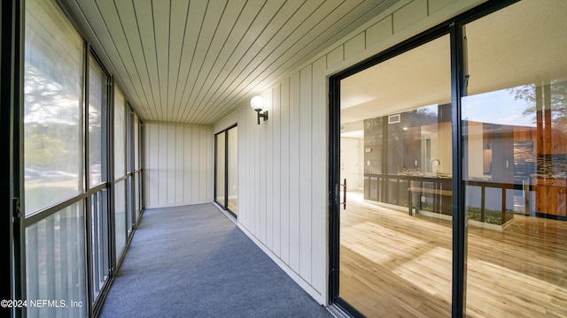 unfurnished sunroom featuring wood ceiling