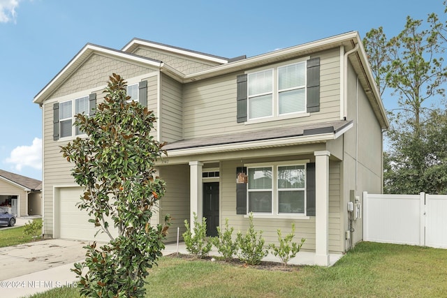 view of front of house featuring a front yard and a garage