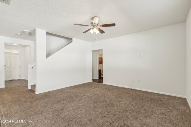 carpeted spare room featuring ceiling fan and a textured ceiling