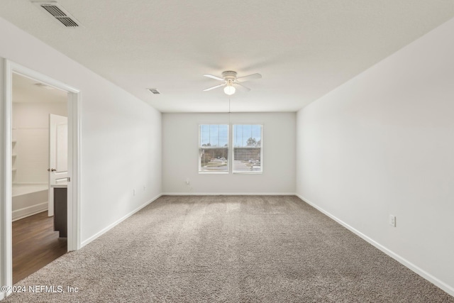 carpeted empty room featuring ceiling fan