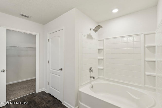 bathroom featuring hardwood / wood-style floors and bathtub / shower combination