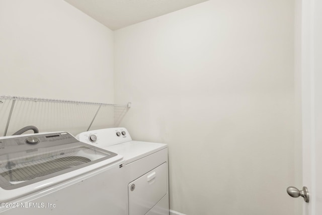 clothes washing area with independent washer and dryer