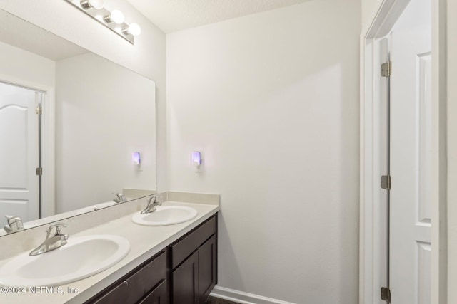 bathroom with a textured ceiling and vanity