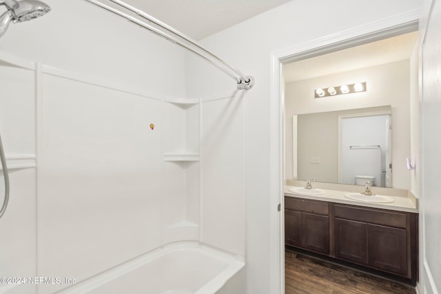 full bathroom featuring wood-type flooring, vanity, toilet, and shower / tub combination