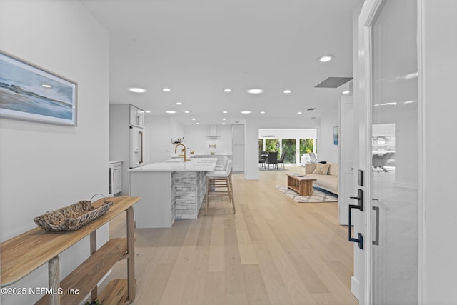 interior space with sink and light wood-type flooring