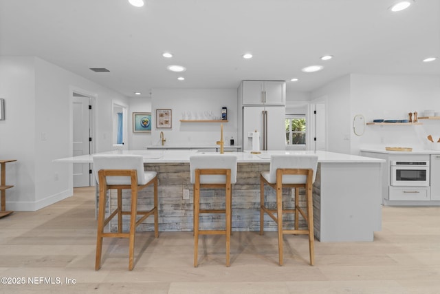 kitchen with a center island, a breakfast bar area, and white cabinets