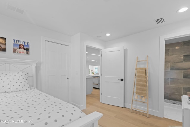 bedroom featuring sink and hardwood / wood-style flooring