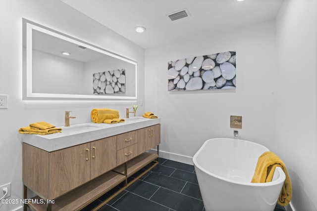 bathroom featuring tile patterned flooring, vanity, and a bath