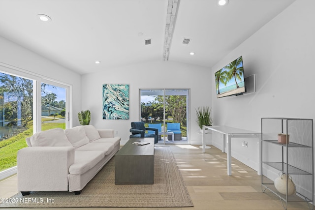 living room featuring vaulted ceiling with beams and light wood-type flooring