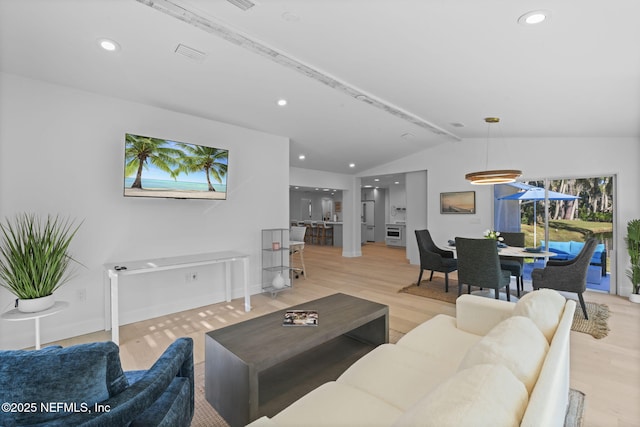 living room with lofted ceiling and light wood-type flooring