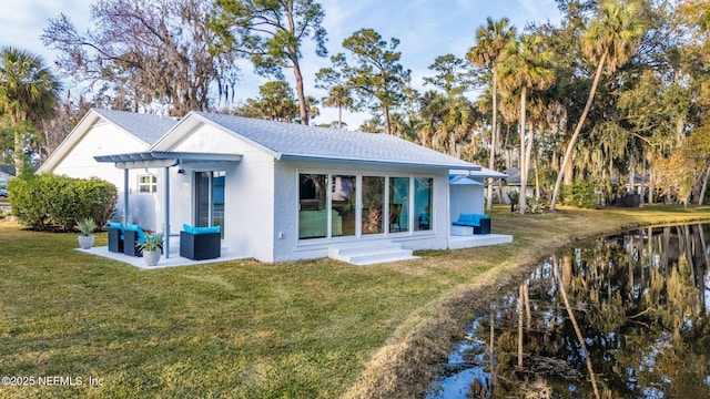 back of house featuring a yard and outdoor lounge area