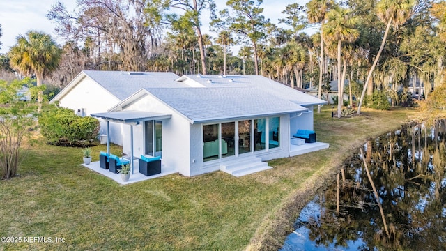 rear view of house with an outdoor living space, a yard, and a patio