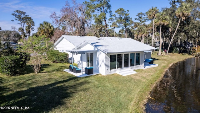 rear view of house with an outdoor hangout area and a lawn