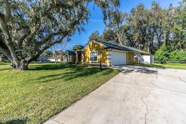 single story home featuring a front yard and a garage