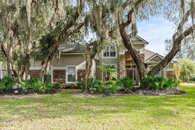 obstructed view of property featuring a front yard