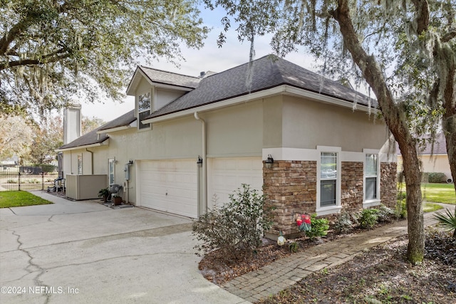 view of side of home featuring a garage