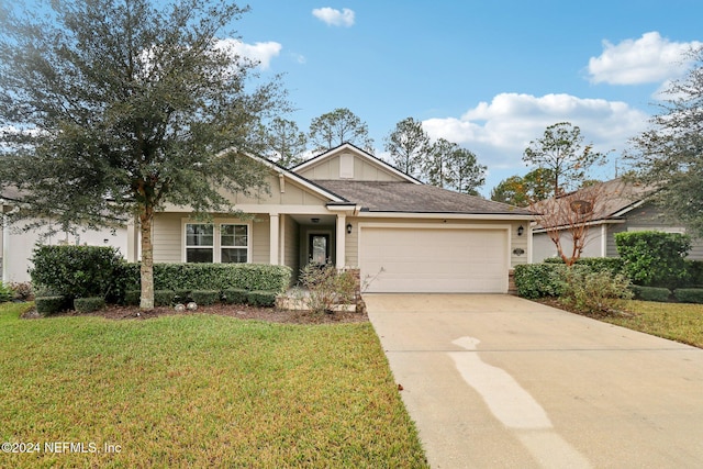 view of front of house featuring a garage and a front lawn