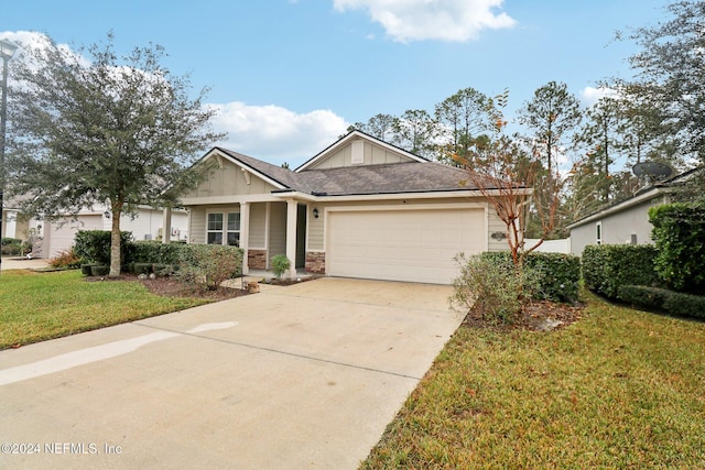 view of front of house featuring a front yard and a garage