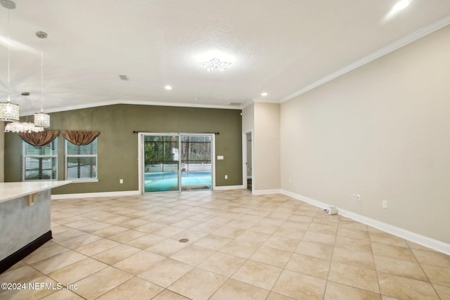 tiled empty room with lofted ceiling, a textured ceiling, and crown molding