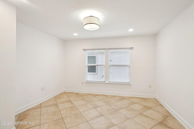 unfurnished room with light tile patterned floors