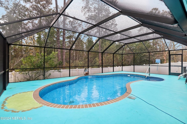 view of swimming pool with glass enclosure