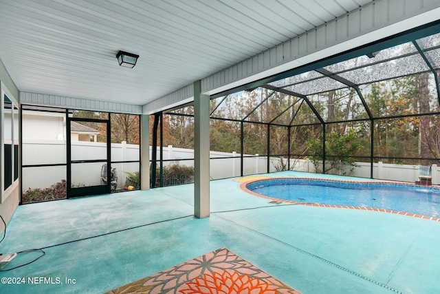 view of swimming pool featuring a lanai and a patio