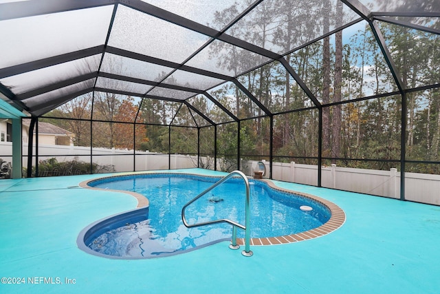 view of swimming pool with glass enclosure