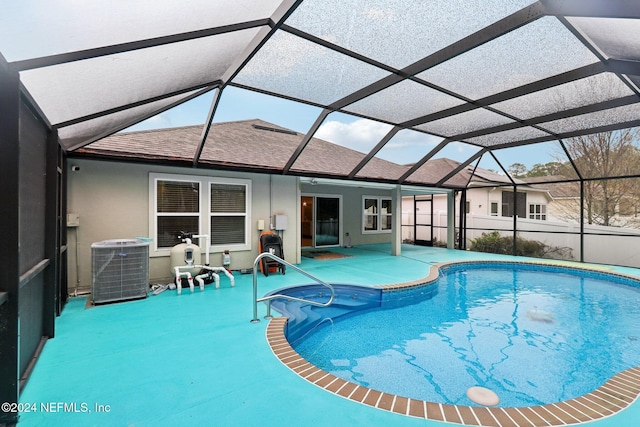 view of pool with a lanai, central AC, and a patio area