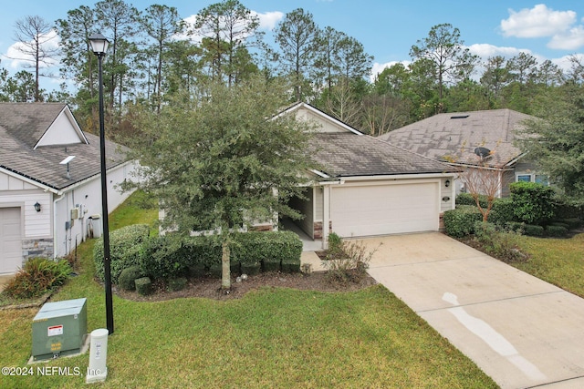 view of front of house featuring a front lawn and a garage