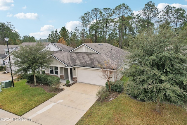 view of front of home featuring a front yard and a garage