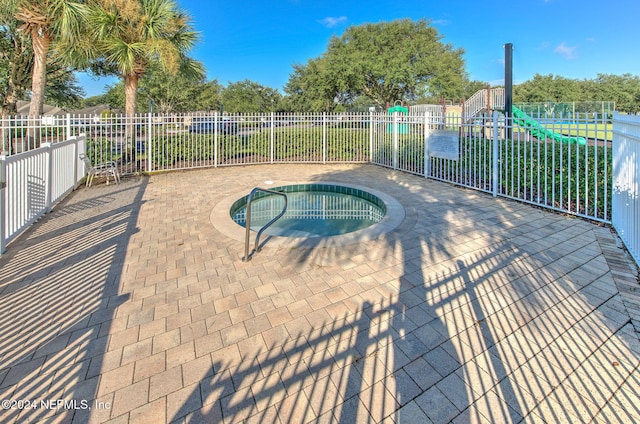 view of swimming pool with an in ground hot tub and a patio