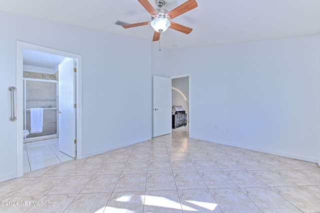 spare room with ceiling fan and light tile patterned floors