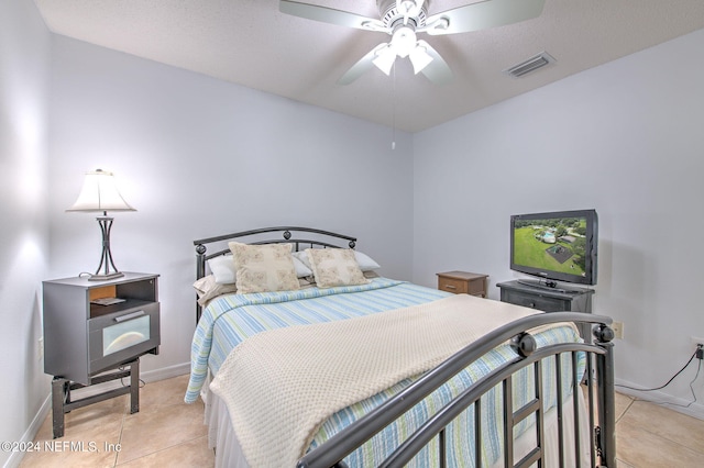 bedroom with ceiling fan and light tile patterned floors