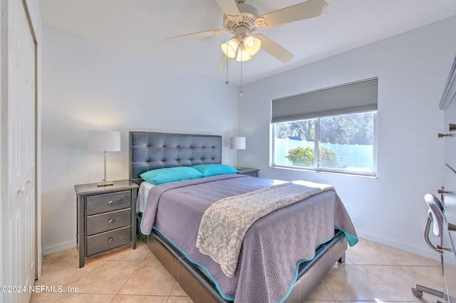 tiled bedroom with a closet and ceiling fan