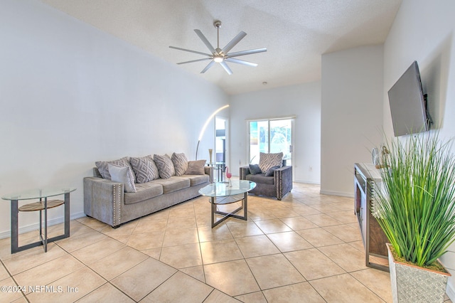 living room featuring a textured ceiling, ceiling fan, lofted ceiling, and light tile patterned flooring