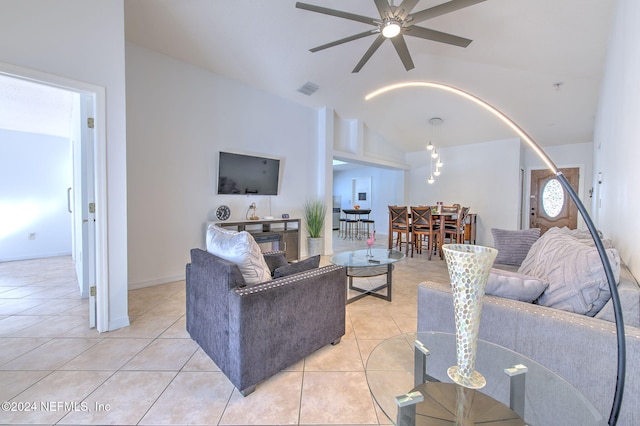 tiled living room featuring ceiling fan and lofted ceiling