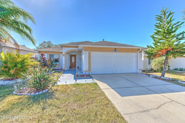 view of front of property featuring a garage and a front lawn