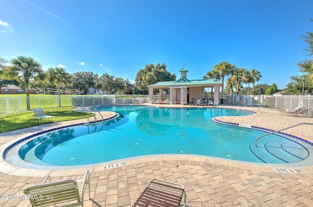 view of swimming pool with a patio area