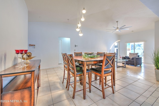 dining area with ceiling fan, light tile patterned flooring, and lofted ceiling