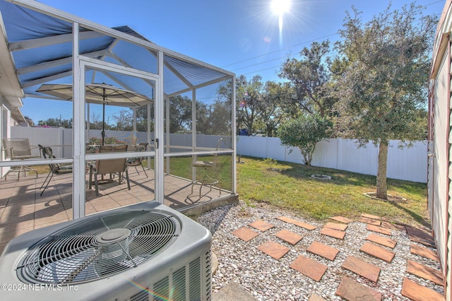 view of patio / terrace with a lanai and central AC