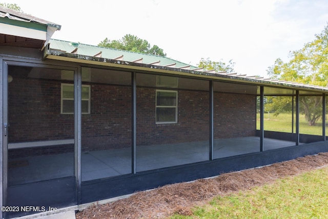 view of side of home featuring a sunroom