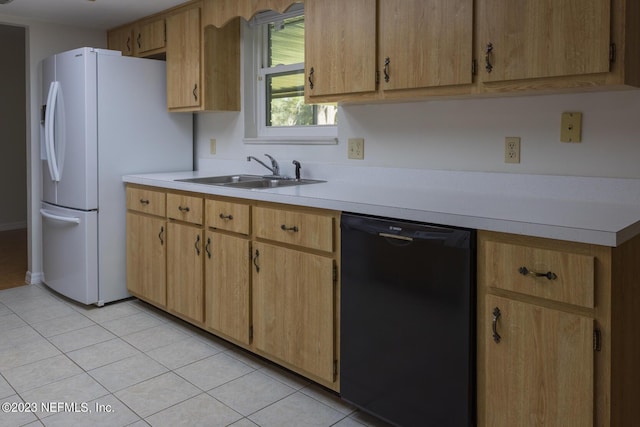 kitchen featuring light brown cabinets, sink, light tile patterned floors, and black dishwasher