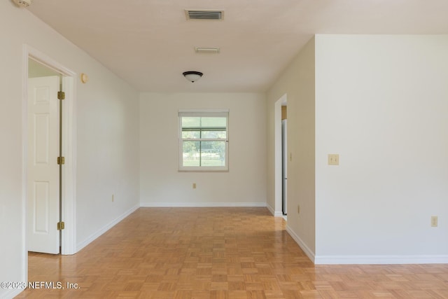 spare room with light parquet floors