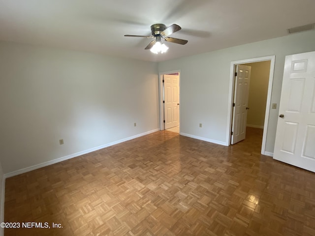 unfurnished bedroom with parquet floors and ceiling fan