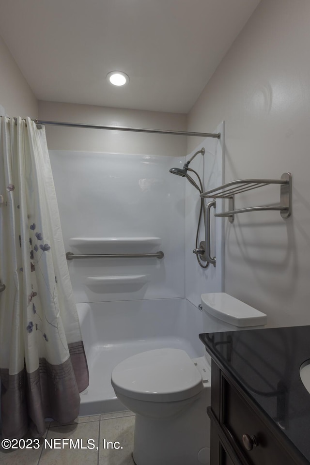 bathroom with tile patterned floors, vanity, toilet, and a shower with shower curtain