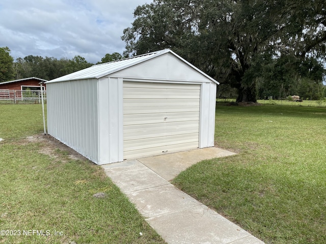 garage featuring a lawn