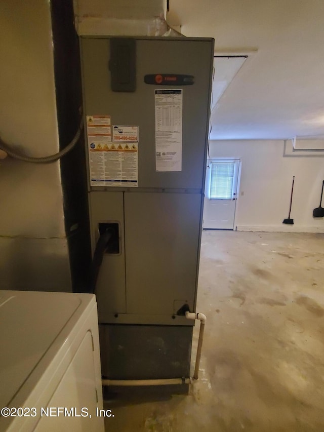 utilities featuring heating unit and washer / dryer