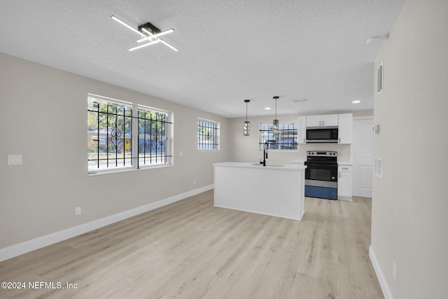 kitchen featuring white cabinets, stainless steel appliances, light hardwood / wood-style flooring, and a wealth of natural light