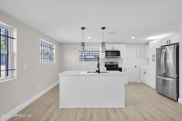 kitchen with sink, white cabinetry, stainless steel appliances, and hanging light fixtures